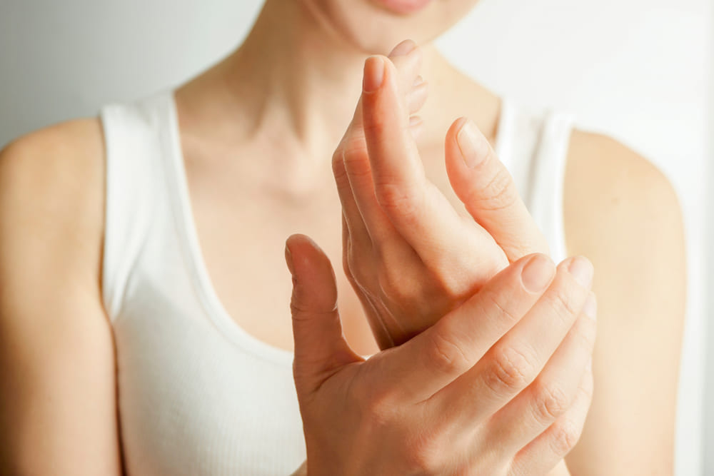 closeup of female hands applying hand cream