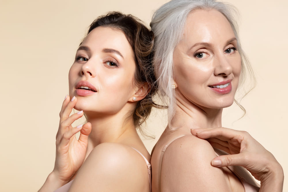 Two beautiful different age woman with perfect skin headshot portrait.