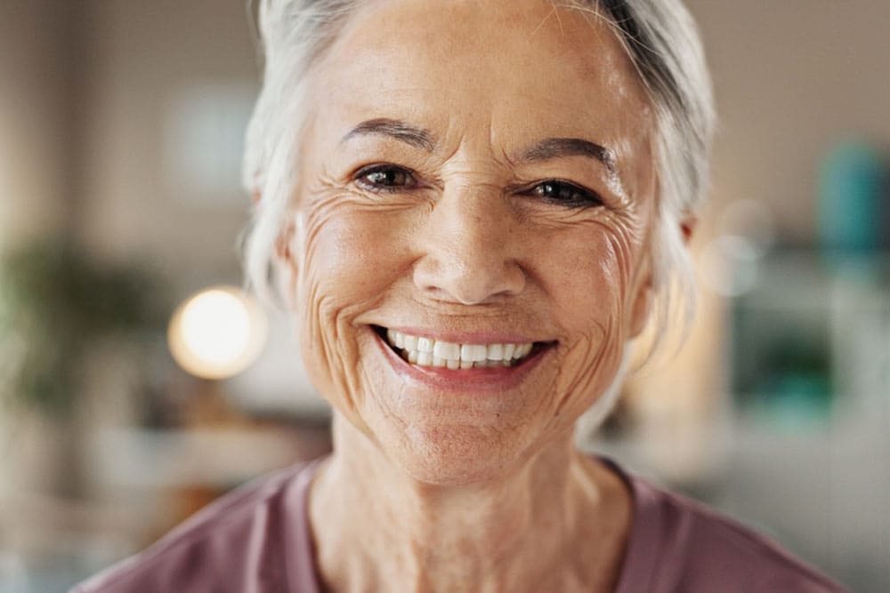 Mature woman, portrait and smile with dental treatment, whitening results and cleaning confidence